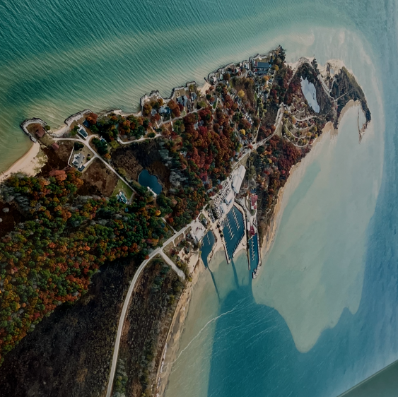 Aerial view of peninsula with marina and houses.